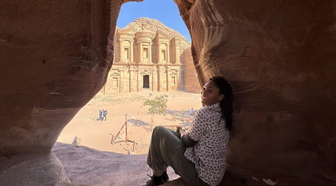 Director, Dayvee Sutton, sitting in the ancient caves of Petra. It's not just  a postcard view, but through the eyes of those whose families once called these ruins home.
