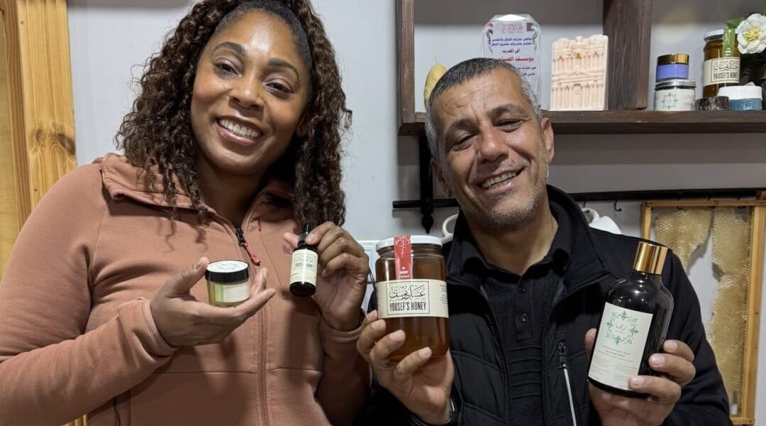 Director, Dayvee Sutton, poses with a local Honey Bee Farm owner after purchasing some goods from him.