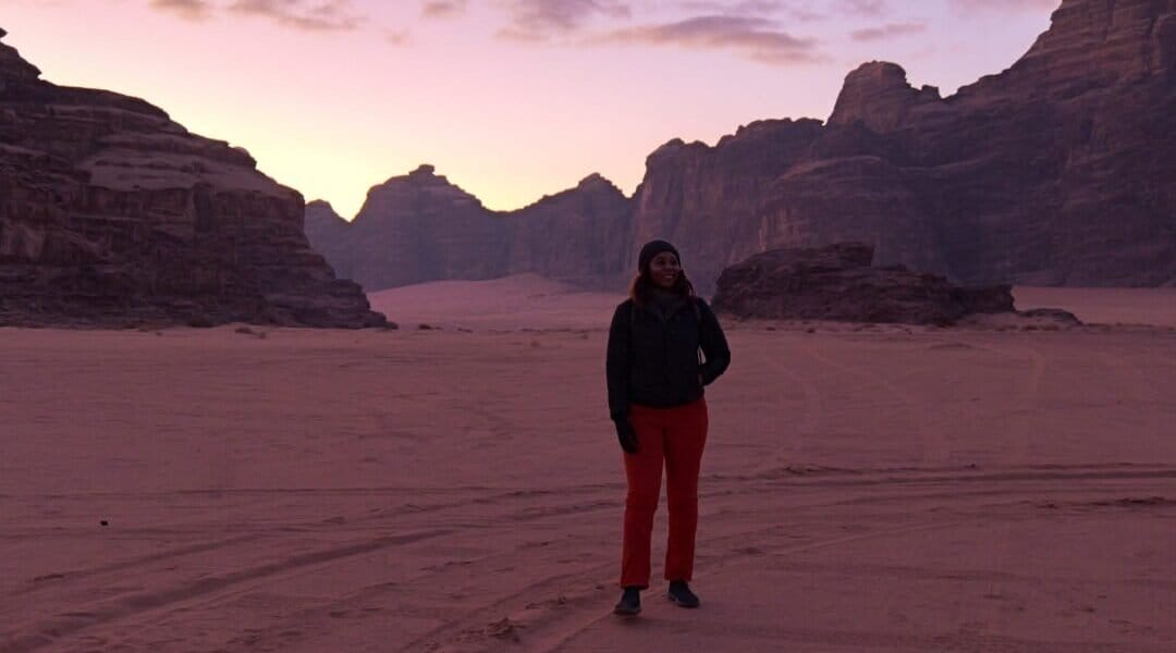 Candid of director, Dayvee Sutton, scoping out the scene at sunrise in Wadi Rum.