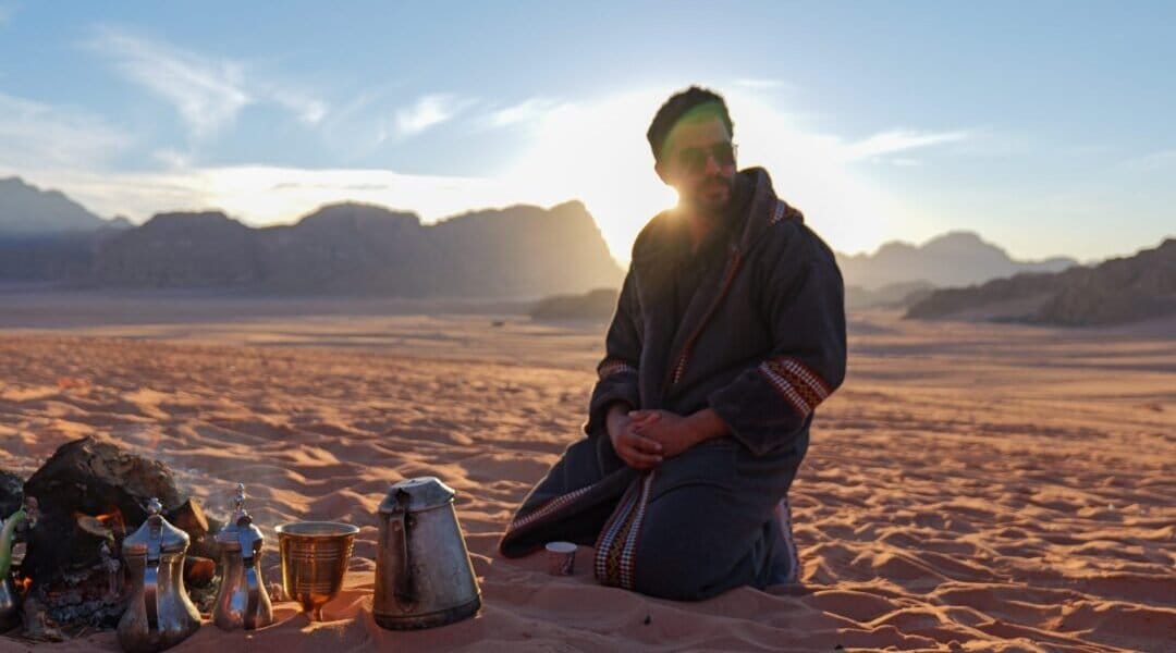 Witness intimate moments of shared tradition, like the timeless ritual of brewing tea in the desert, a symbol of Jordanian hospitality.